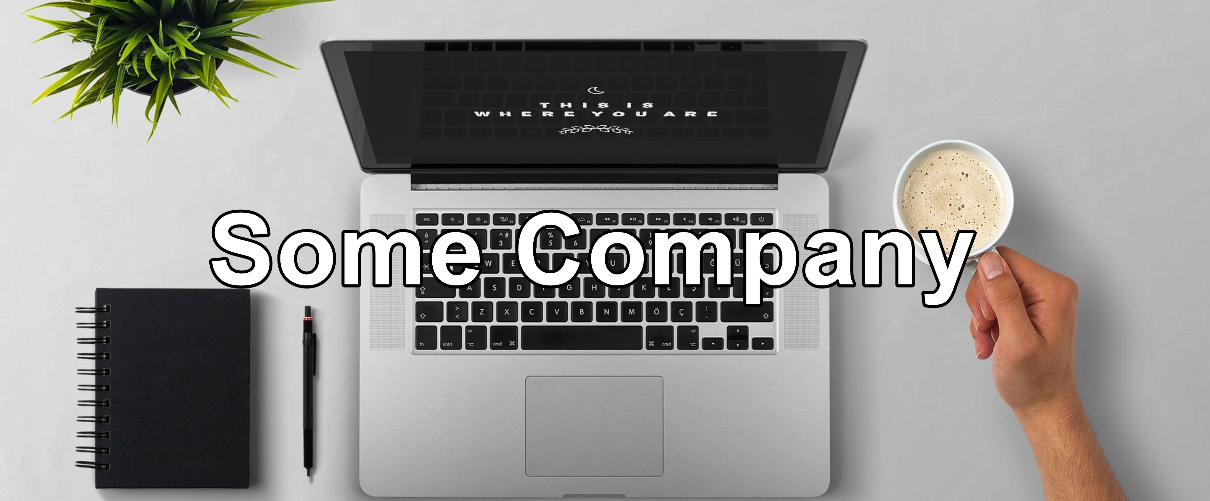 laptop with coffee cup and a notebook. Text says 'Some Company'